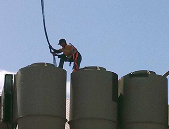 Worker erection silos on a cotton gin project