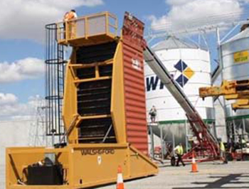 Conveyor filling grain into a shipping container that is standing vertical using the container inverter system